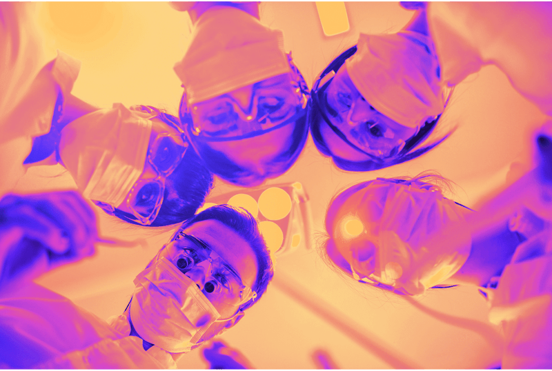Group of dental professionals looking over a case together